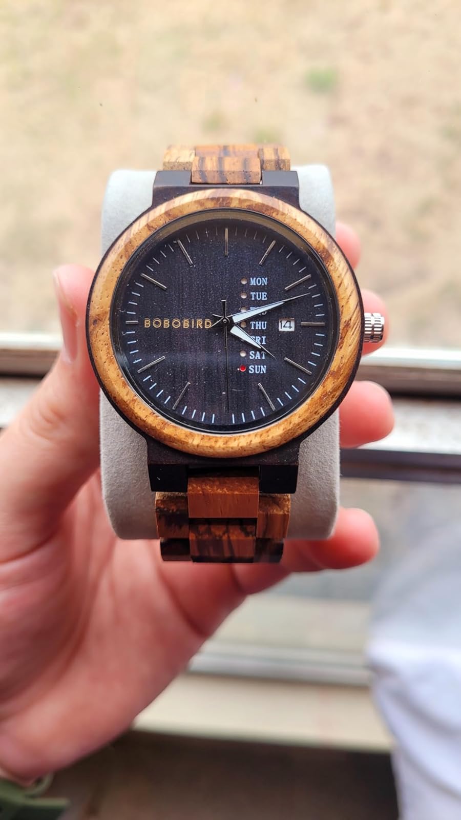 Why does a person choose to wear a natural wood wristwatch?